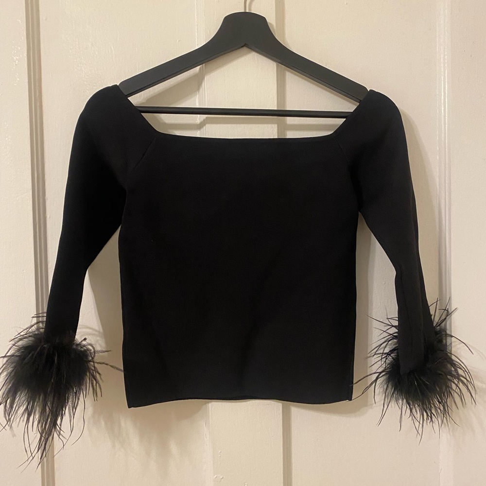 Black top with feather cuffs